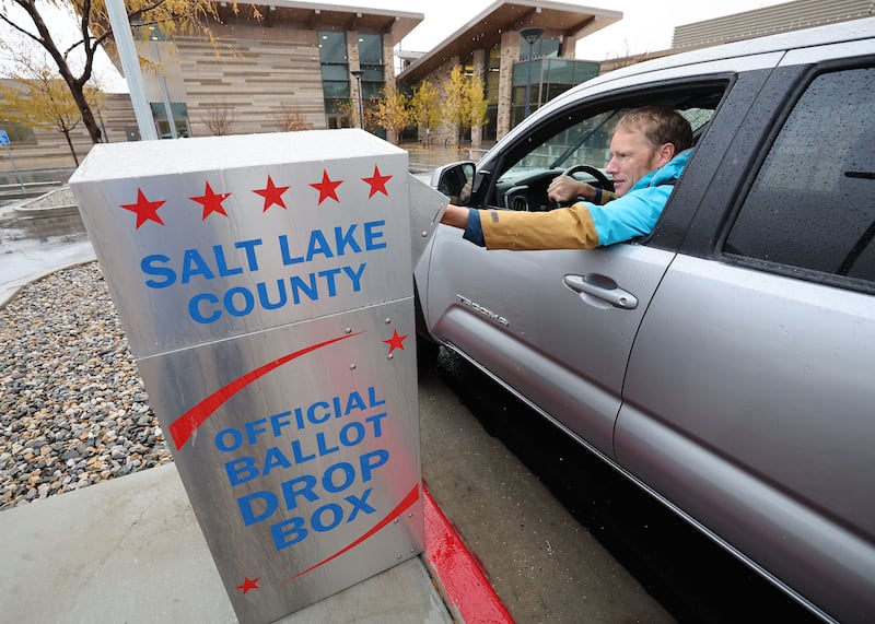 Guy Evans casts his mail-in ballot in Cottonwood Heights, Utah.