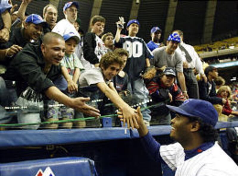 Montreal Expos third baseman Tony Batista bids farewell to fans at team's final home game.