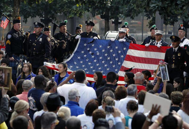 In this Sept. 11, 2013, file photo, the World Trade Center flag is presented as friends and relatives of the victims of the 9/11 terrorist attacks gather at the National September 11 Memorial at the World Trade Center site, for a ceremony marking the 12th
