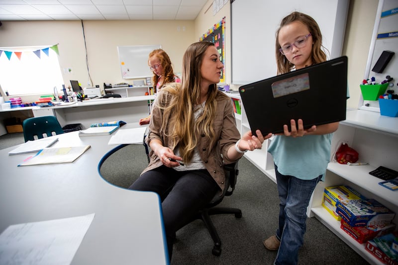 Teacher Sierra Westwood helps Gracie Allen at Antimony Elementary on Oct. 30, 2018. Antimony is one of 23 Utah schools that have moved to a 4-day week.