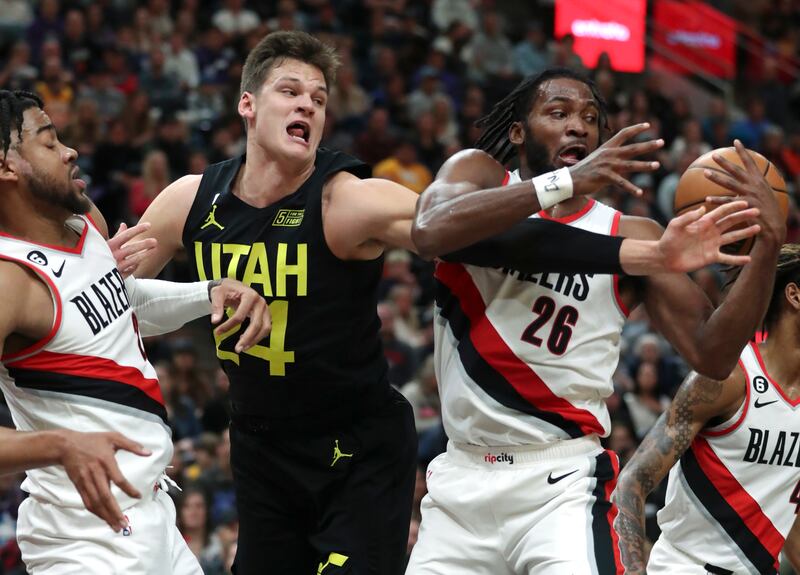 Portland Trail Blazers forward Trendon Watford (wearing white), Utah Jazz center Walker Kessler (wearing black).