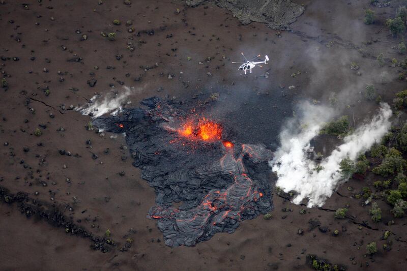 Scientists fly in a helicopter above the Pu'u O'o vent on Kilauea Volcano on Sunday, March 6, 2011 on The Big Island, Hawaii.