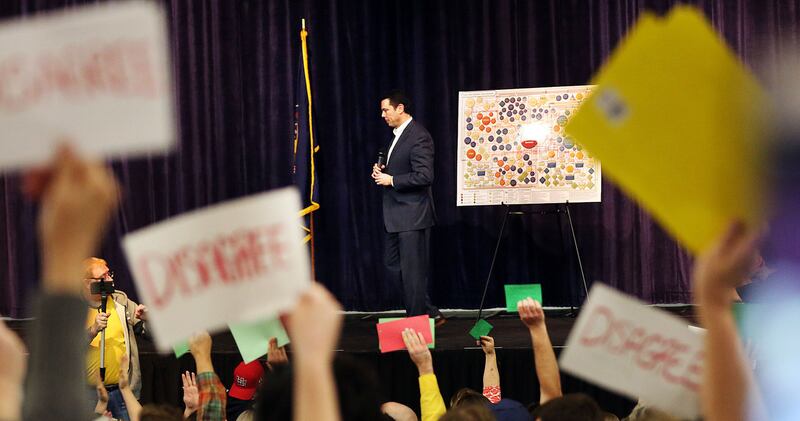 FILE - Rep. Jason Chaffetz listens to questions as many of those in attendance hold signs and yell during a town hall meeting at Brighton High School in Cottonwood Heights on Thursday, Feb. 9, 2017.