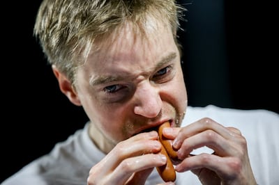 Steve Hammond, of Kirkland, Wash., stuffs hot dogs in his mouth on his way to winning a Nathan's Famous qualifier hot dog-eating contest, having eaten 32 hot dogs, at Smith's Ballpark in Salt Lake City on Tuesday, July 23, 2019. The top male and female fi