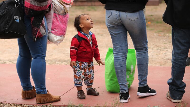 An asylum-seeker toddler looks at his mother as they arrive at the Casa Alitas shelter at the Benedictine Monastery in Tucson, Arizona, on Saturday, Feb. 9, 2019.