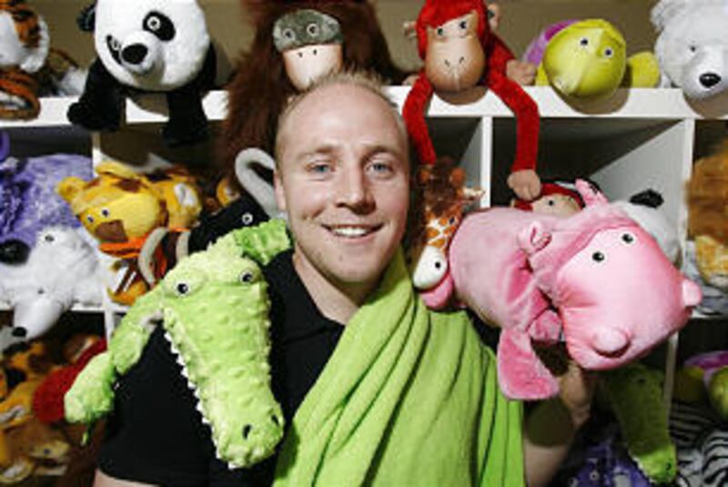 Ryan Treft, one of the owners of a company called Zoobies, shows off some of the stuffed animals the company creates.