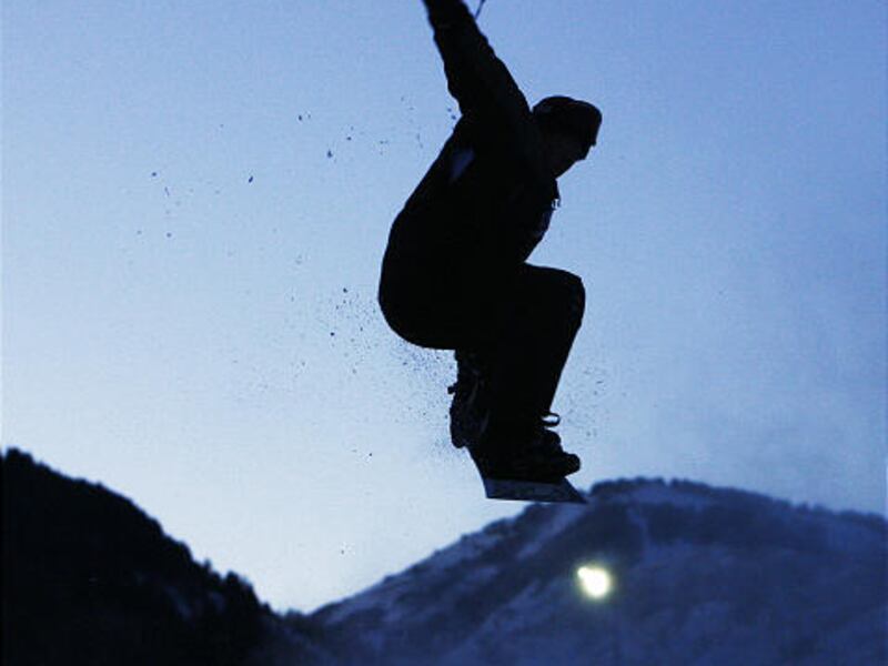 A snowboarder takes to the air while enjoying the great outdoors during a cold winter's day at Wolf Mountain near Eden, Utah.