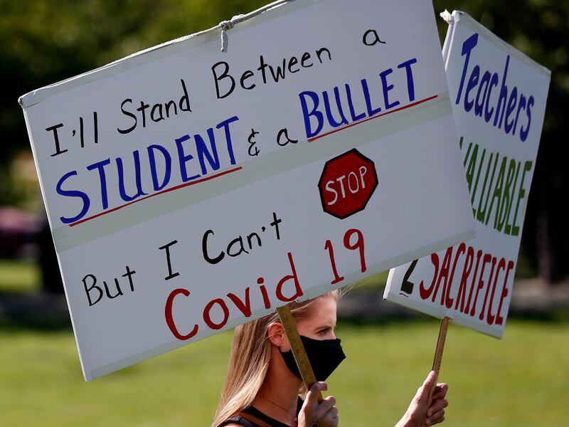 A teacher protests, urging masks in schools.