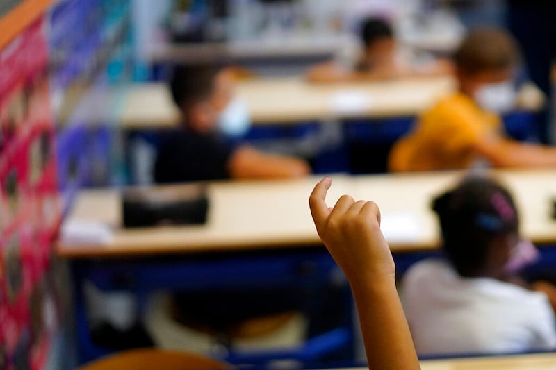A child raises his finger as France went back to school.