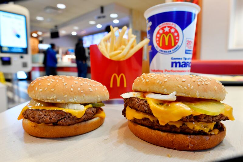In this March 6, 2018 photo, a McDonald’s Quarter Pounder, left, and Double Quarter Pound burger is shown with fresh beef in Atlanta.