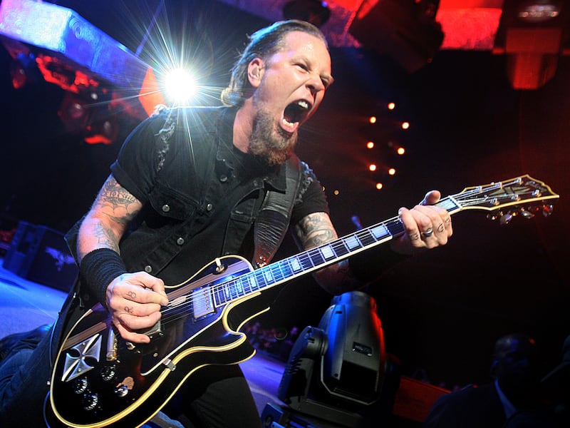 Metallica lead singer James Hetfield plays his guitar for fans during their concert.