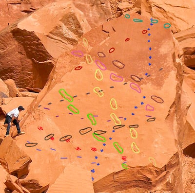 Veteran dinosaur tracker Andre Delgalvis discovered a feast of dinosaur tracks — noted by the different colors — in on a slab estimated to be 52 feet wide and 68 feet high near Lake Powell on March 14, 2018. A recent rockfall brought the dinosaur tracks i