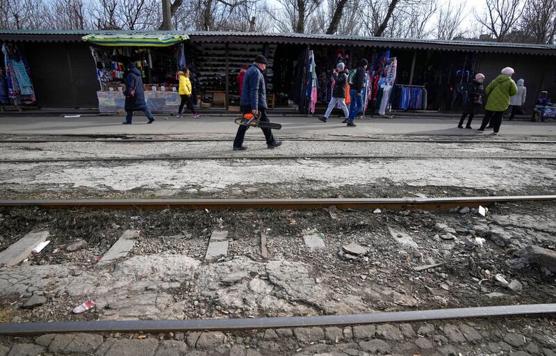Local residents pass in Mariupol, Ukraine.