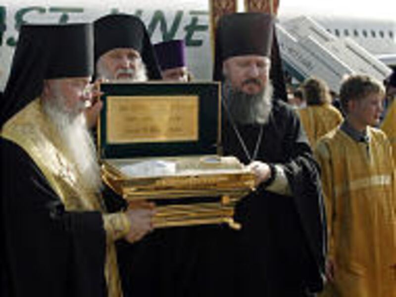 Russian Orthodox priests carry a golden ark containing the remains of Grand Duchess Elizabeth upon its arrival in Moscow from Jerusalem.