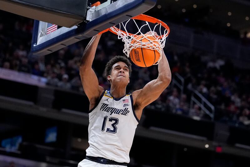 Marquette forward Oso Ighodaro dunks the ball in the second half of a first-round college basketball game against Western Kentucky in the NCAA Tournament Friday, March 22, 2024, in Indianapolis, Ind. (AP Photo/Michael Conroy)