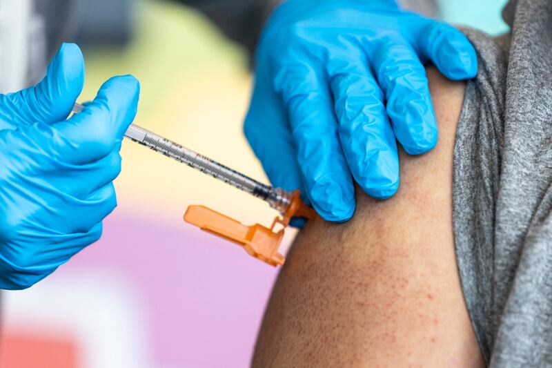 Nurse Cathy Martin administers a COVID-19 booster shot to Sergio Ruiz at the Kearns Library in Kearns on Sept. 29, 2022.