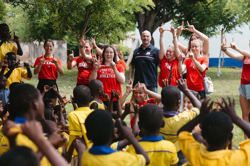 Members of the University of Utah gymnasts team and young African students flash the "U" during Engage Now Africa Education Day in Ghana earlier this this month.