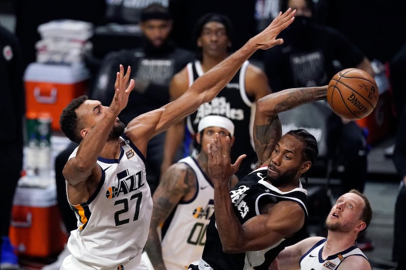 Los Angeles Clippers forward Kawhi Leonard passes the ball as Utah Jazz center Rudy Gobert defends in Game 3 of their playoff series.