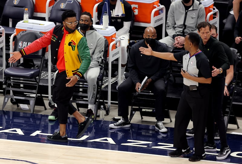 Jazz guard Donovan Mitchell is directed to the end of the bench by referee as the Utah Jazz and the Memphis Grizzlies play.