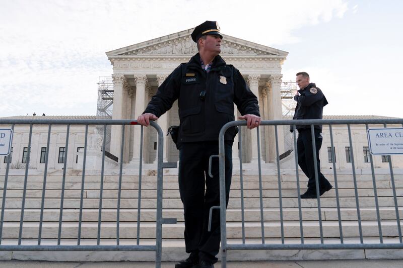 Police put a fence outside of the U.S. Supreme Court on Thursday, Feb. 8, 2024, in Washington.