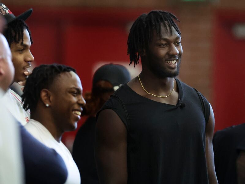 Former Utah linebacker Devin Lloyd, right, watches pro day at the Spence & Cleone Eccles Football Center in Salt Lake City.