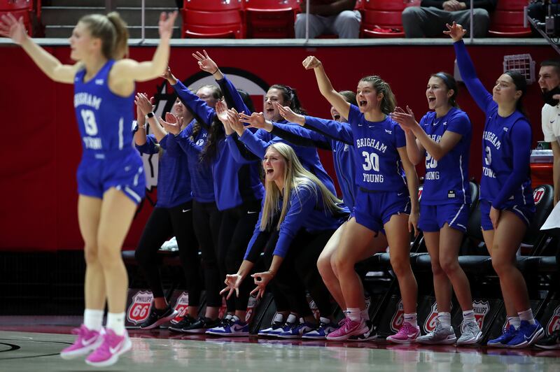 BYU Cougars players react after a 3-point make as Utah and BYU women compete in a basketball game at the Huntsman Center in Salt Lake City on Saturday, Dec. 4, 2021.