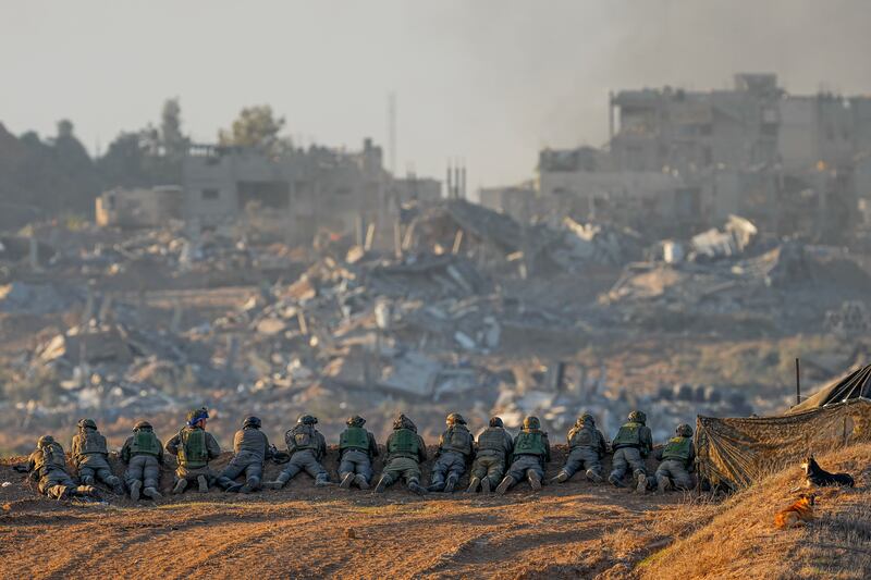 Israeli soldiers take positions near the Gaza Strip border, in southern Israel on Dec. 11, 2023. The army is battling Palestinian militants across Gaza in the war ignited by Hamas’ Oct. 7 attack into Israel.