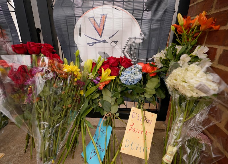 Memorial flowers and notes line walkway at Scott Stadium at the University of Virginia in Charlottesville. Va.