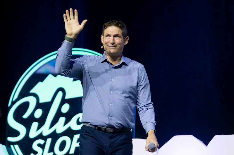 Steve Young, former BYU and NFL quarterback, waves as he leaves the stage after speaking during the Silicon Slopes Summit at the Vivint Arena in Salt Lake City on Friday, Sept. 30, 2022.