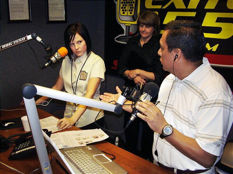 Sasheen Horn, left, and Jill Laws of the Utah Driver License Division and Tony Yapias discuss changes on the radio.