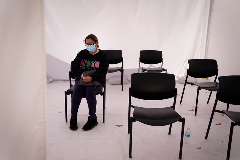 Margarita Hernandez, margarita Hernandez, who tested positive for the coronavirus, waits in a tent to see a doctor for her allergic reaction to medication at Providence Holy Cross Medical Center in the Mission Hills section of Los Angeles, Tuesday, Dec. 22, 2020.ho tested positive for the coronavirus, waits in a tent to see a doctor for her allergic reaction to medication at Providence Holy Cross Medical Center in the Mission Hills section of Los Angeles, Tuesday, Dec. 22, 2020.