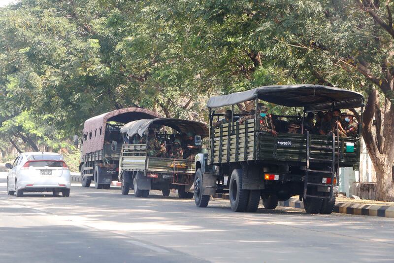 Soldiers sit inside trucks parked on a road in Naypyitaw, Myanmar, Monday, Feb. 1, 2021. Myanmar military television said Monday that the military was taking control of the country for one year, while reports said many of the country’s senior politicians including Aung San Suu Kyi had been detained.