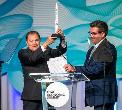 Gov. Gary R. Herbert holds up a miniature of a Minuteman missile presented to him by Rich Choppa, program director of  Missile and Weapon Systems, Defense, Space & Security at Boeing at the 13th annual Utah Economic Summit at the Grand America Hotel in Sa