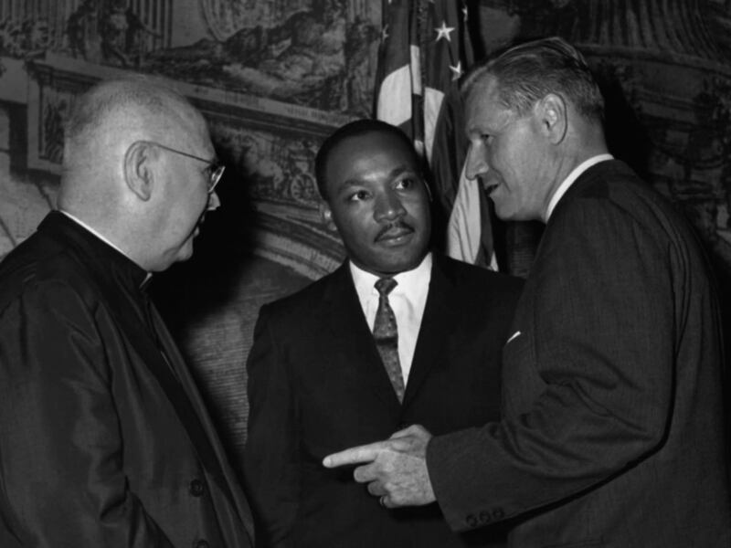 Civil rights leader Dr. Martin Luther King, Jr., center, talks with Francis Cardinal Spellman, archbishop of New York, left, and Gov. Nelson Rockefeller in New York on Sept. 12, 1962.