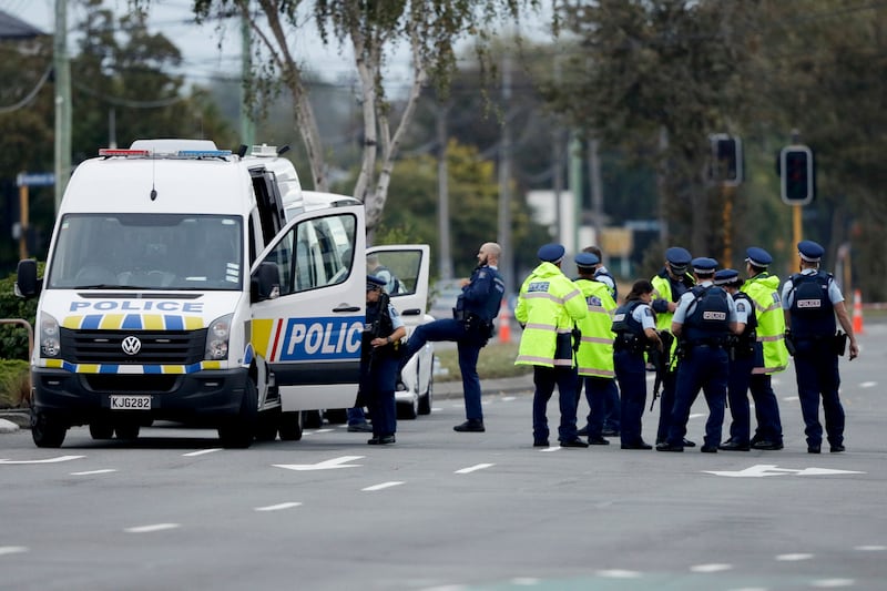Police gather outside the Linwood mosque, site of one of the mass shootings at two mosques in Christchurch, New Zealand, Saturday, March 16, 2019.