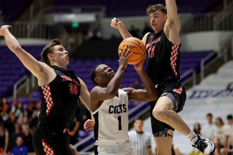 Cottonwood’s Jackson Price goes to the hoop between Timpview’s James Rust and Colton Smith.