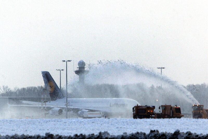 Snow is being removed from a runway next to a Lufthansa aircraft at the airport in Frankfurt, central Germany, on Thursday, Dec. 9, 2010. Due to heavy snowfalls all runways of the Frankfurt airport had to be closed for four hours late Wednesday.