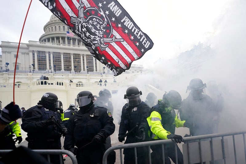 Police hold off supporters of Donald Trump who tried to break through a police barrier at the Capitol in Washington