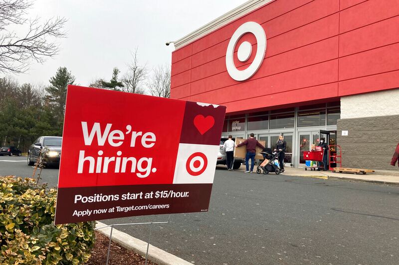 A hiring sign is in front of a Target store.