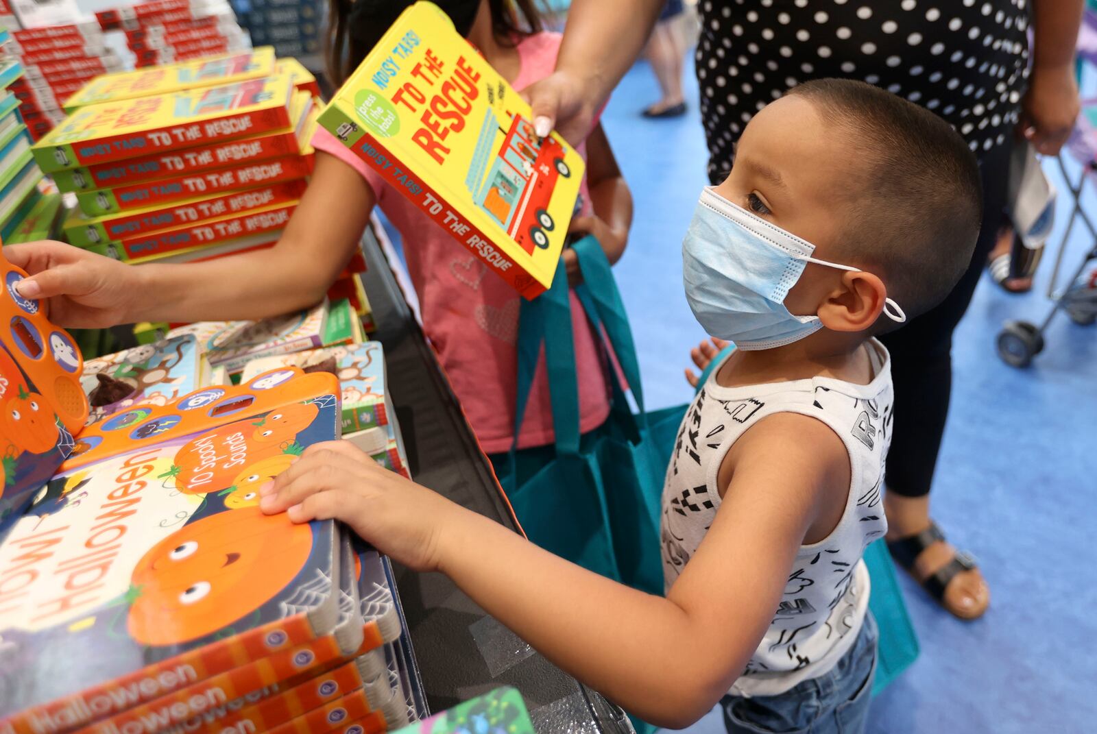 Ruben Gomez picks out a book at the Salt Lake County Library in Kearns.