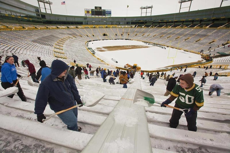 Green Bay Packers fans shovel out Lambeau Field Monday, Feb. 7, 2011, in Green Bay, Wis. The team will be hosting a victory celebration on Tuesday. The Packers defeated the Pittsburgh Steelers 31-25 in Super Bowl XLV.