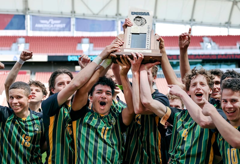 St. Joseph celebrates after beating Maeser Prep in the 2A boys soccer state championship game at America First Field in Sandy on Friday, May 12, 2023.
