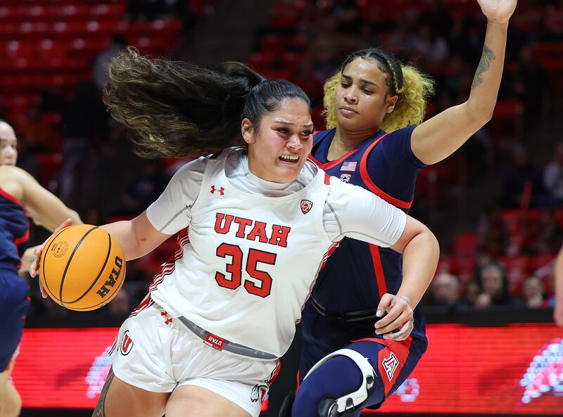 Utah Utes forward Alissa Pili (35) moves around Arizona Wildcats forward Esmery Martinez (12) on her way to the hoop.