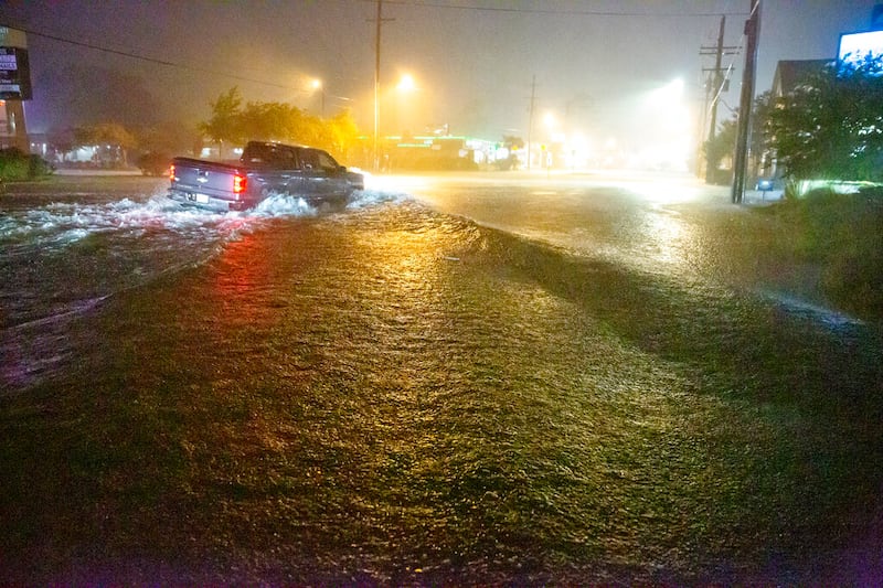 Motorists navigate a flooded Gause Boulevard in Slidell, La., as a tropical disturbance neared the Louisiana shore.