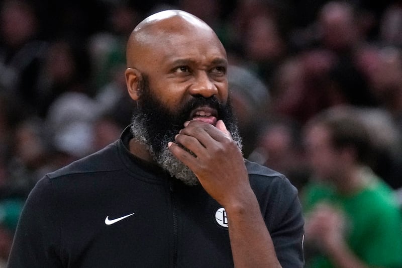 Brooklyn Nets head coach Jacque Vaughn looks towards the scoreboard during the first half of an NBA basketball game.