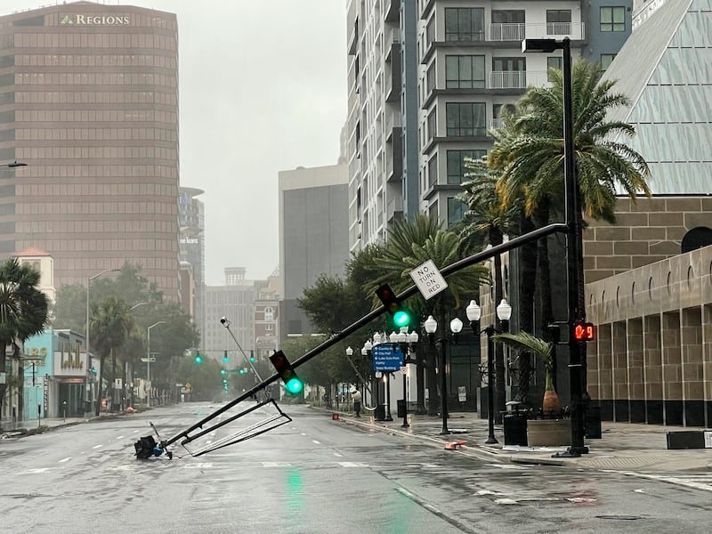 A stoplight pole at Livingston Street, blown down by Hurricane Ian winds, rests on Orange Avenue in Downtown Orlando, Fla.