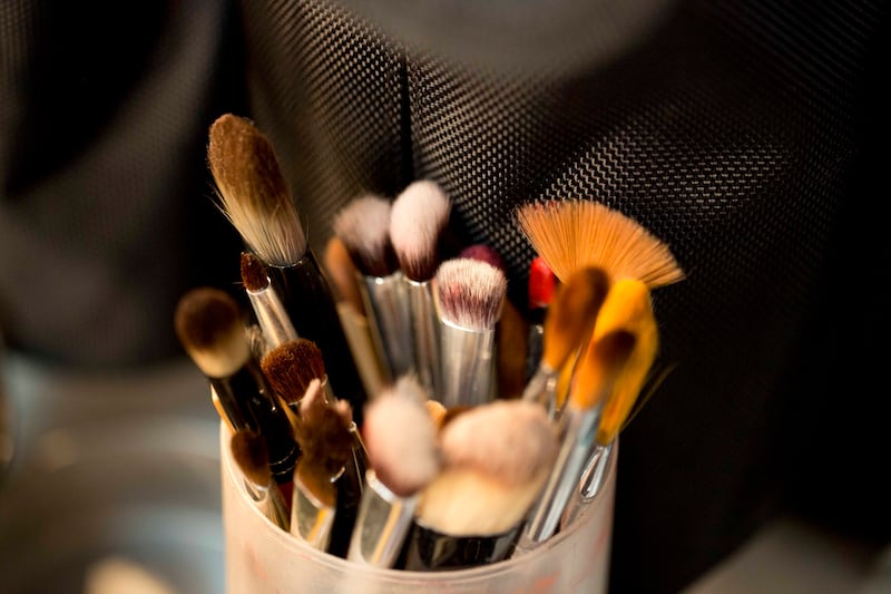 Makeup brushes stand in a container on a worktable at the Mercedes Benz Fashion Week Mexico in Mexico City.