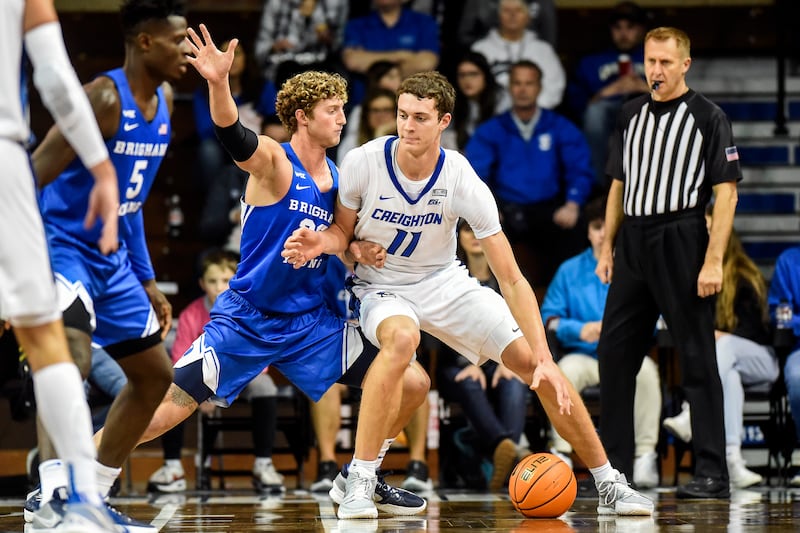 Creighton’s Ryan Kalkbrenner (11) battles his way to the basket as BYU’s Caleb Lohner (33) defends.
