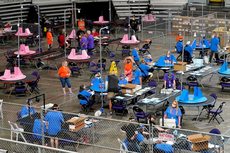 Workers examine ballots cast in Maricopa County, Arizona in 2020.