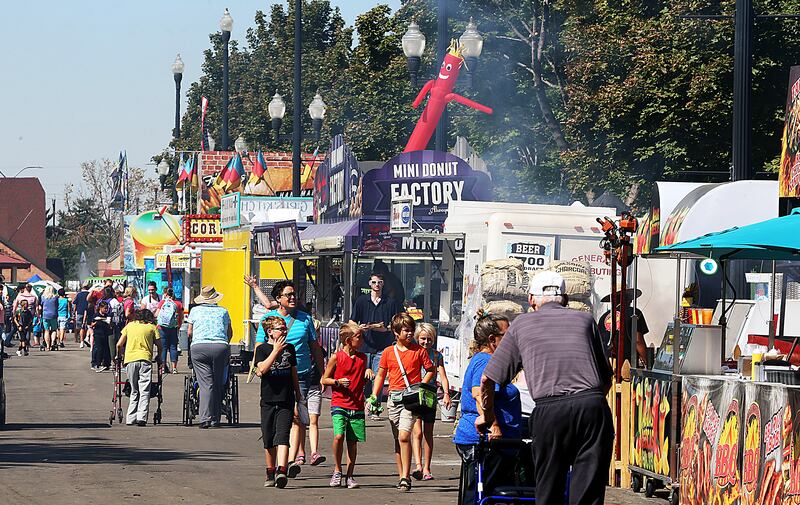 Fair attendees search out food options at the Utah State Fair in Salt Lake City on Monday, Sept. 11, 2017.